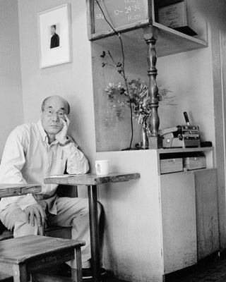 A Pondering Japanese gentleman in a Tokyo café