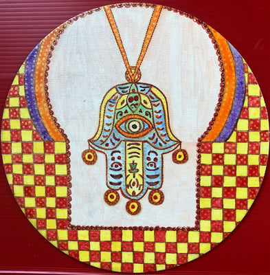 A Hamsa hanging from a store window in Morocco.