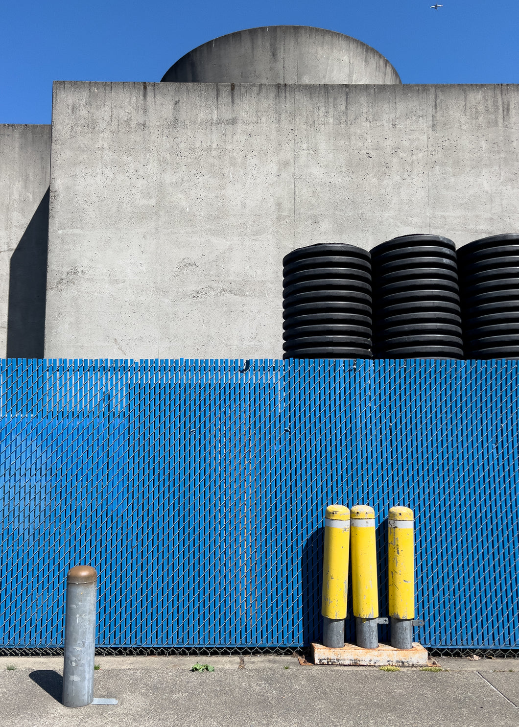 yellow poles blue fence  small-1752119681700.jpg